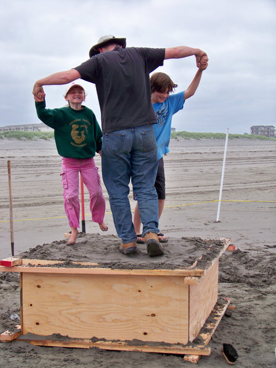 Packing sand with helpers.